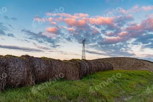 Preview: Electrical Pylon With Hay Bales At Sunset In The Tuscan Hills