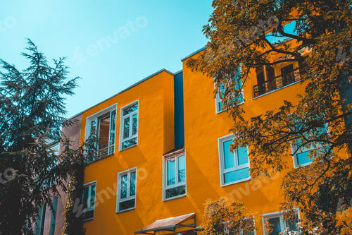 Preview: Modern Orange Apartment Building Framed By Trees