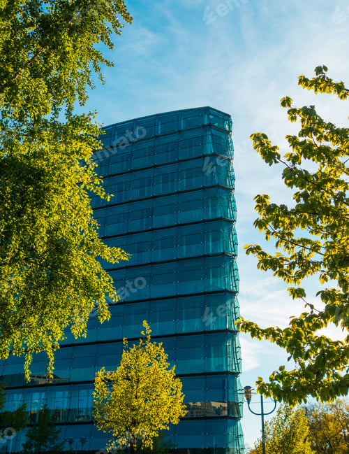 Preview: High Angle Format Of An Glass Building Framed With Trees
