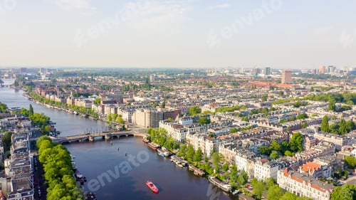 Preview: Amsterdam, Netherlands. Flying Over The City Rooftops. Amstel River, Aerial View