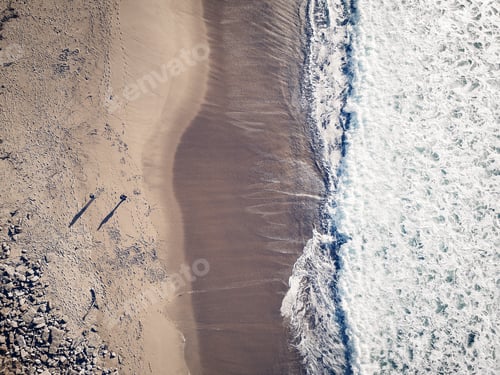 Preview: Aerial View From A Couple Walking In A Sandy Beach. Drone Photo