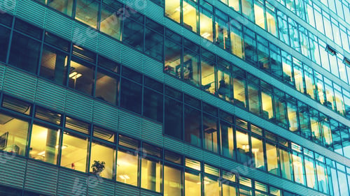 Preview: Glass Front Of Office Building With Yellow Lights Inside
