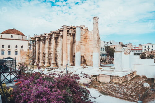Preview: Old Partially Restored Greek Ruins Near Church With Purple Flowered Tree In Foreground