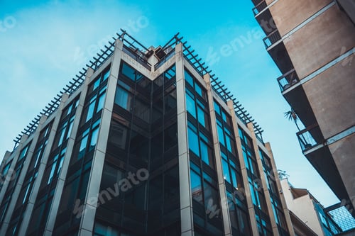 Preview: Contemporary Office Building With Unusual Roof Beside Other Urban Edifice