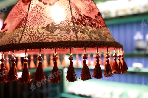 Preview: View Of Red Lampshade With Tassels In Cafe