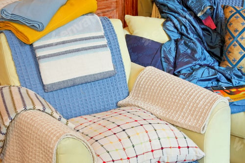 Preview: Bunch Of Pillows And Blankets Over Armchair