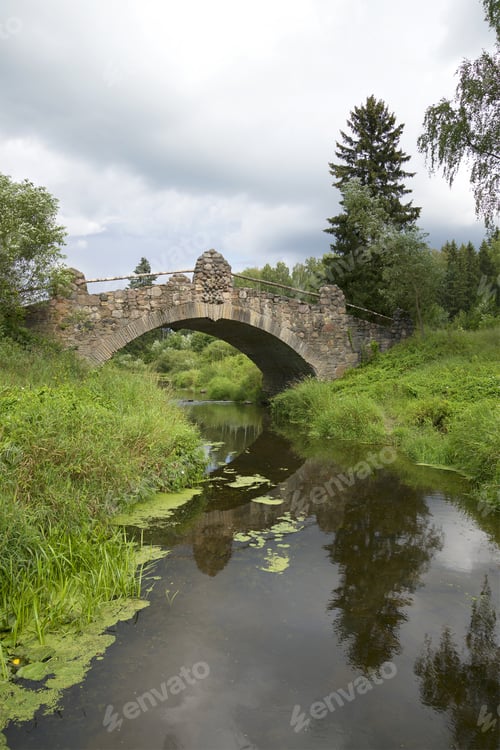 Preview: Old Stone Bridge Over The River Slavyanka Cloudy Day. Pavlovsk