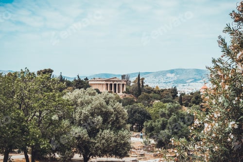 Preview: Tree Orchard With Ancient Greek Temple And Little Mountains In The Distance Under Hazy Sky