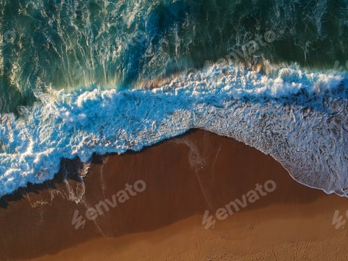 Preview: Aerial View From A Sandy Beach With Waves At The Sunset. Drone Photo