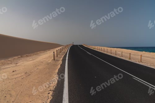 Preview: Asphalt Road On Desert Sand Dune At Sunset In Corralejo Natural Park In Canary Islands
