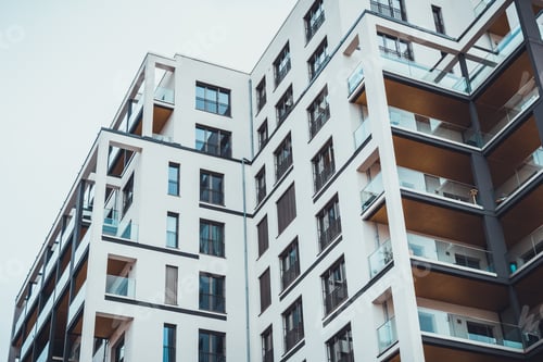 Preview: White Facade On Large Condominium Flats With Glass Windows And Barriers On Balconies