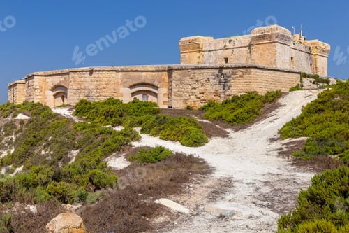 Preview: The Ancient Stone Tower Of St. Lucian And The Fort Over The Bay. Marsaxlokk. Malta.