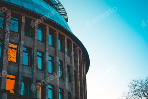 Preview: Curved Marble Building With Orange Reflections In The Windows