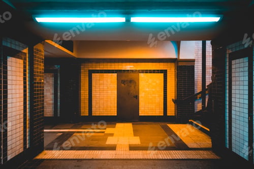 Preview: Yellow And Blue Lighted Underground Station With White And Black Tiles In The Night