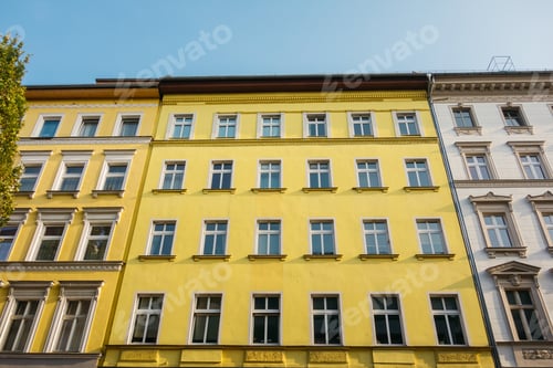 Preview: Yellow Facade Of Apartment Building In Low Angle View