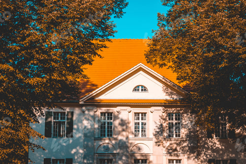 Preview: Historical Building With Red Roof And Autumn Trees