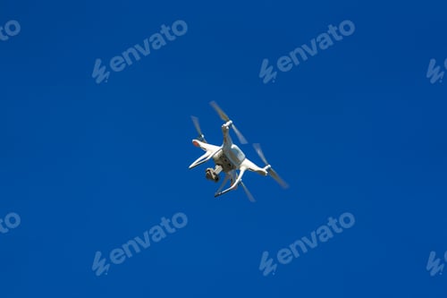 Preview: White Flying Copter Against The Blue Sky