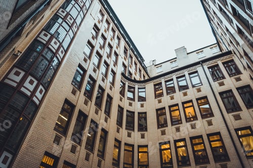 Preview: Low Angle View On Rounded Corners On Luxury Apartment Condo Brick Building Under Gray Sky