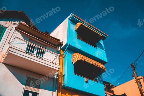 Preview: Low Angle View Of Orange And Blue Colored Buildings