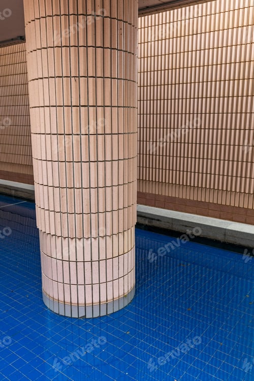 Pink Tiled Column Reflecting Blue Tiled Floor