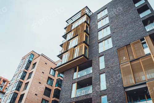 Preview: Low Angle View Of Unique Contemporary Housing Complex With Gated Porches Colored Orange
