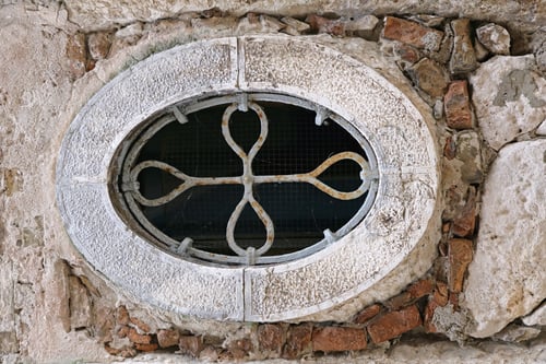 Preview: Oval Stone Window With Iron Safety Bar At Ruined House
