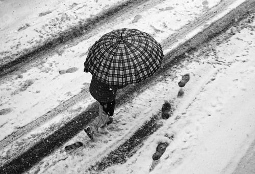 Preview: Woman Walking In Snow On Urban Street, Winter Season