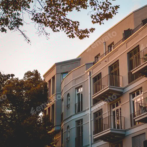 Preview: Square Formated Picture Of White Apartment House With Green Tree On The Side