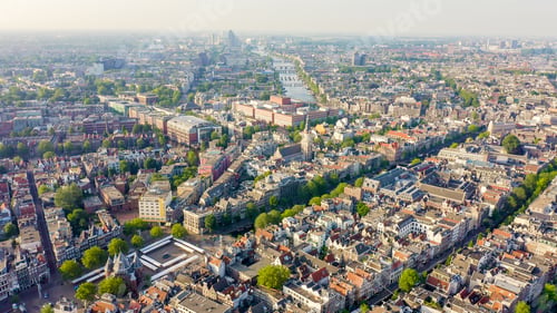 Preview: Amsterdam, Netherlands. Flying Over The City Rooftops Towards Amsterdam Central Station ( Amsterdam