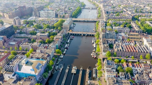 Preview: Amsterdam, Netherlands. Flying Over The City Rooftops. Amstel River, Amstel Gateways, Aerial View