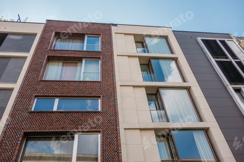 Preview: Brown Brick Facade, Next To White And Grey Townhouse Building With Big Glass Windows
