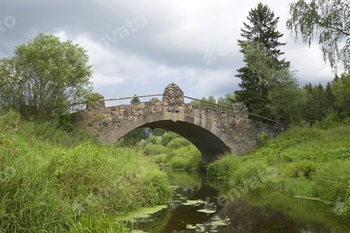 Preview: Old Stone Bridge On The River Slavyanka Cloudy August Day. Pavlovsk, Russia