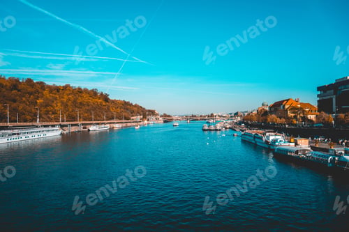 Preview: View Down The Vitava River, Prague In Evening Autumn Light With Boats Moored Along The Banks Under