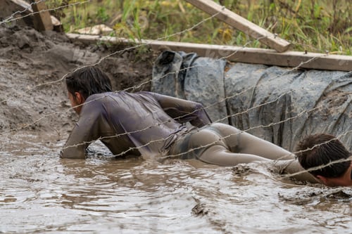Preview: Woman Crawling Under Barbed Wire At An Obstacle Course Race