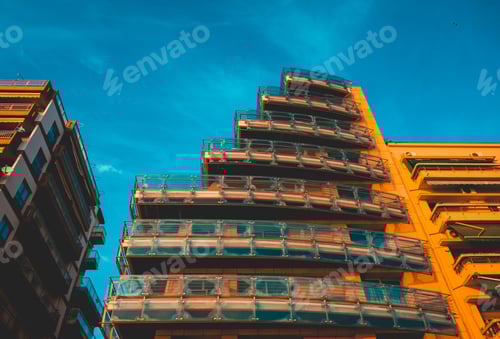 Preview: Low Angle View Of Warm Colored Apartment Building With Stairs Architecture And Glass Balconys