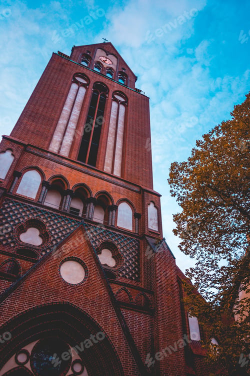 Preview: Historical Brick Church From The Low Angle View With Beautiful Tree And Colorful Sky