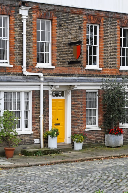 Preview: Old English House With Brick Wall And Yellow Door