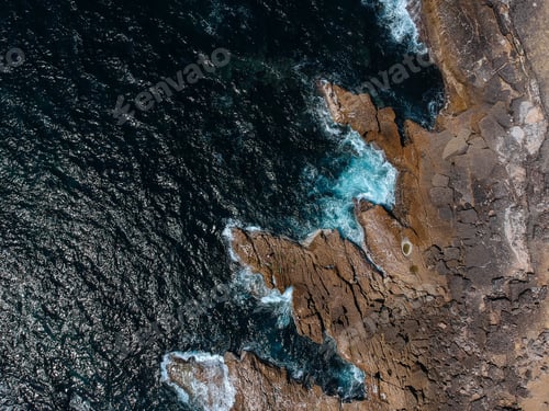 Preview: Aerial Top View Of Sea Waves Hitting Rocks On The Beach With Turquoise Sea Water. Amazing Rock