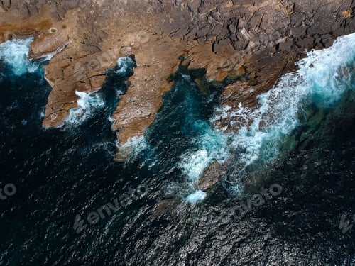 Preview: Aerial Top View Of Sea Waves Hitting Rocks On The Beach With Turquoise Sea Water. Amazing Rock