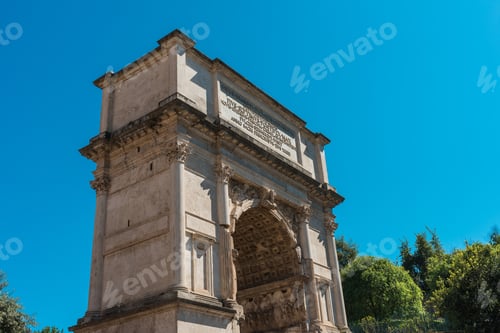 Preview: Triumphal Arch Of Titus Viewed From The Side And Low Angle Against Clear Blue Sky, With Green Tree