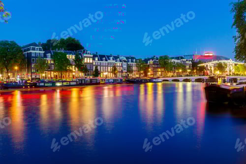 Preview: City Canal With Glowing Lights Early In The Morning. Amsterdam. Netherlands.
