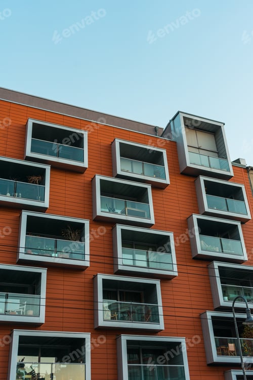 Preview: Modern Apartment House With Red Facade And Futuristic Balconies