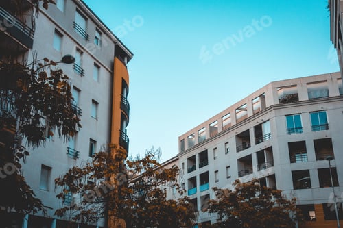 Preview: White Apartment Houses In A Vanishing Point View With Blue Copy Space In The Middle