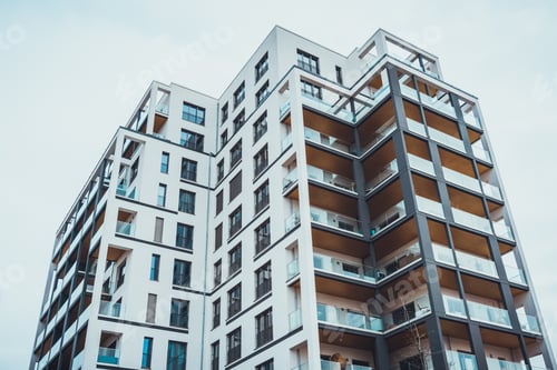 Preview: Low Angle View On High Rise Flats With Square Windows And Glass Barrier Balconies