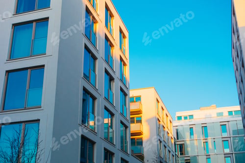 Preview: Blue Colored Apartment House With Yellow Sunlight On The Facade