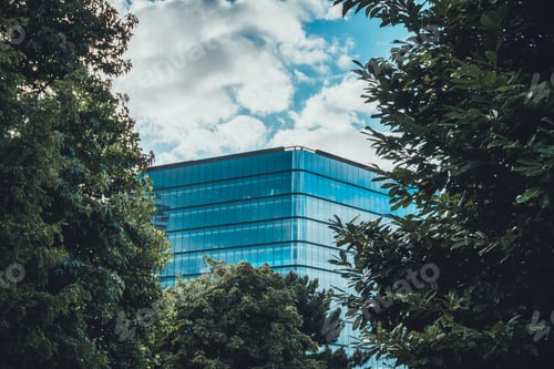 Preview: Glass Office Building In The Middle Of Green Treetops