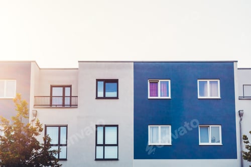 Preview: White And Blue Townhouses In Warm Sunlight