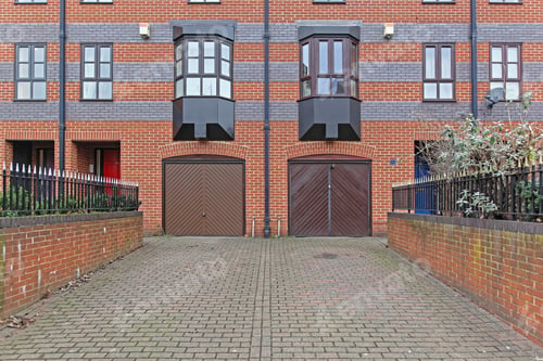 Preview: Two Garage Doors With Driveway At Residential Building