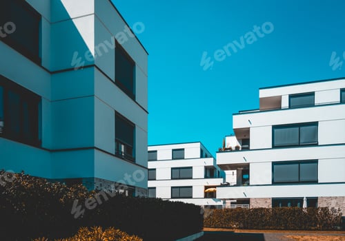 Preview: White Facaded Apartment Buildings With Darken Sky And Copy Space In The Center