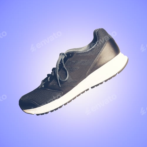 Preview: Single Canvas And Leather Sneaker Or Trainer In An Artistic Diagonal Side View With Glow Effect